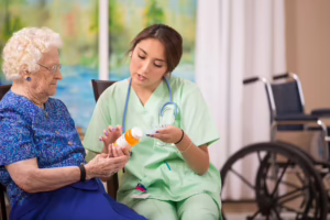 Medical assistant explaining medication to elderly patient