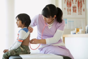 Pediatric medical assistant examining child 