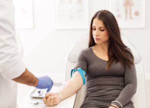 Phlebotomist preparing patient for blood draw