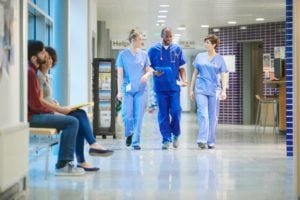 Nurses chatting in hospital hallway 