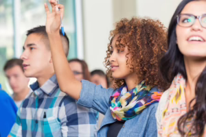 College student raises hand to ask question