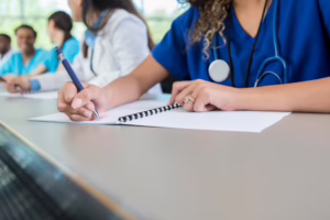 Students In Scrubs Taking Notes 