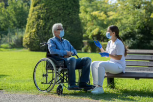 Patient in wheelchair with medical assistant