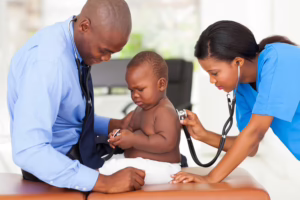 Medical assistant examining baby