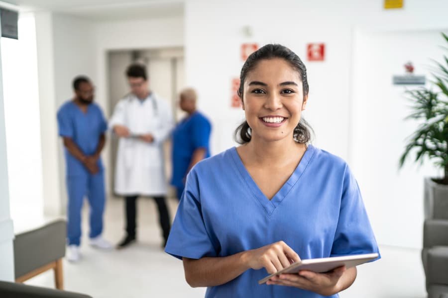Smiling nurse using a tablet