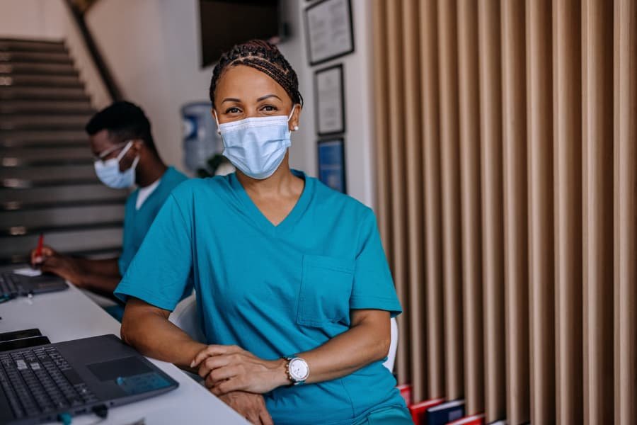 Medical assistant posing with mask on 