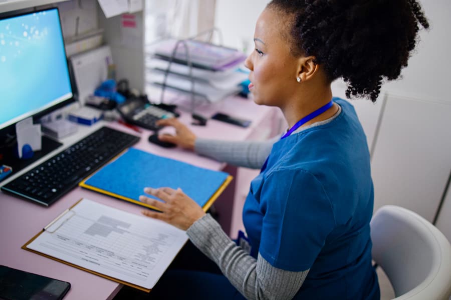 Nurse using computer to work in private clinic