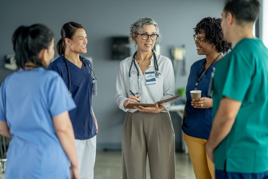 Nurse preceptor advising team of nursing students