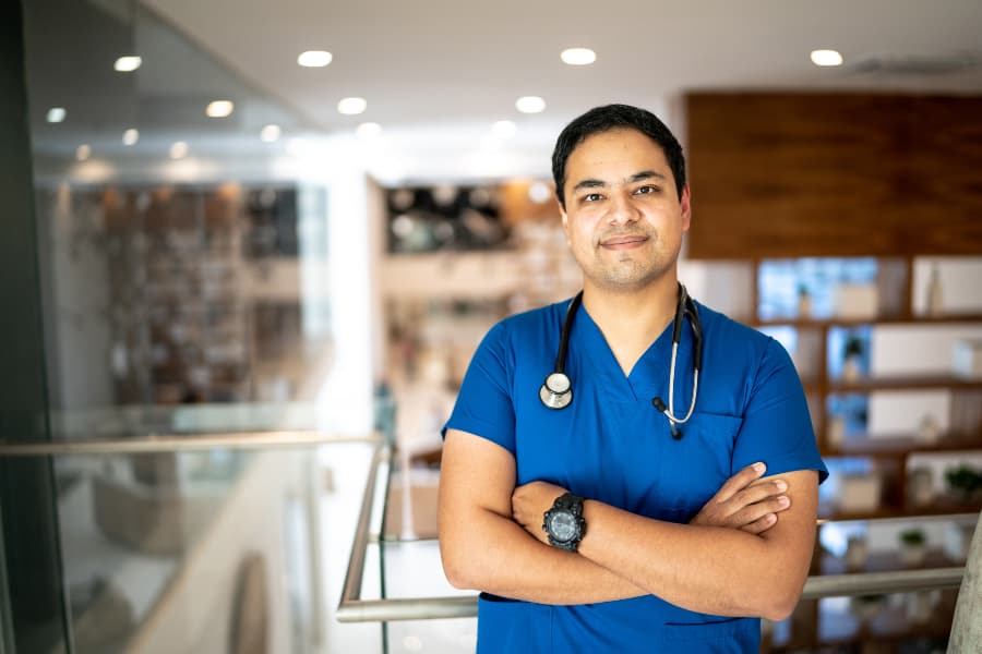 Smiling nurse in scrubs at hospital