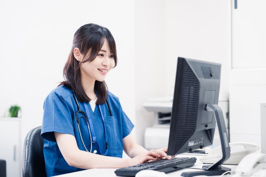 Medical worker doing clerical work on computer