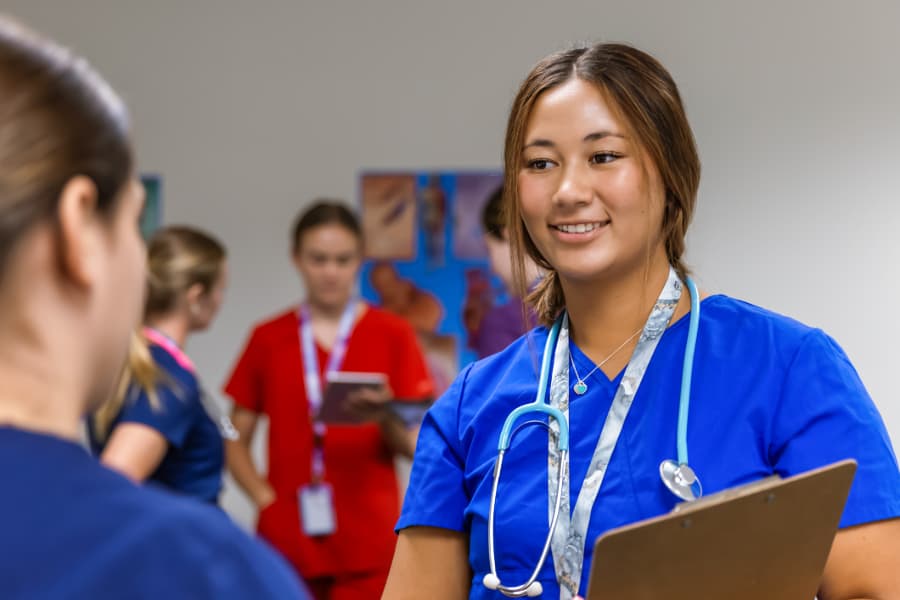 Nursing students talking in hallway after class