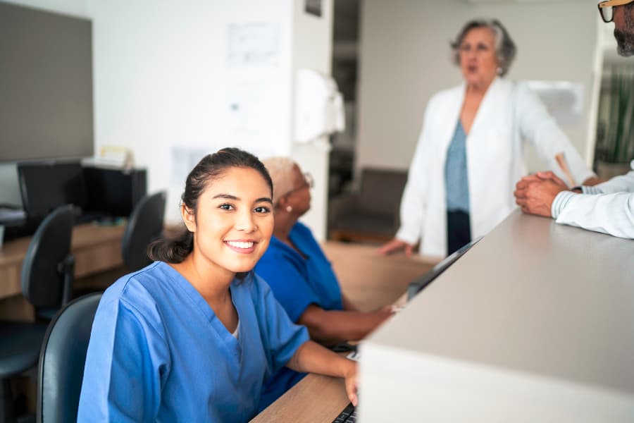 Young medical assistant working at hospital reception