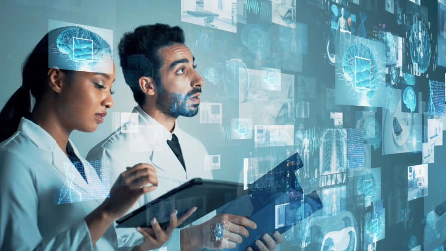 Two doctors checking tablet screens with medical scans overlay
